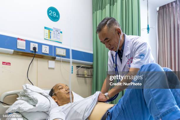 Gastroenterologist Tian Chuanzai examines a patient in Chongqing, China, August 18, 2023. August 19th is the Chinese Doctor's Day.