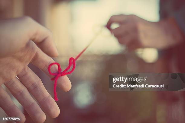 Red Thread Connecting Photos and Premium High Res Pictures - Getty Images
