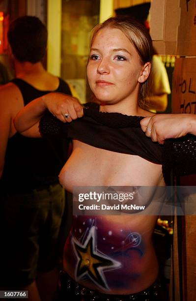 Chelsea Linton, of Rapid City, South Dakota, flashes a young passerby on Main Street at the risk of being cited by police during the 61st annual...