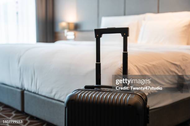 a suitcase in a luxury hotel room - hotel stock-fotos und bilder