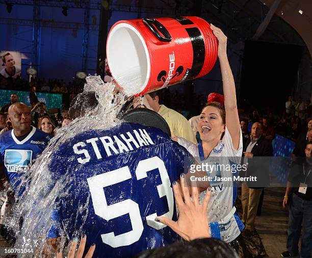 Blue Team Coach Michael Strahan and Maria Menounos celebrate his team's win at DIRECTV'S Seventh Annual Celebrity Beach Bowl at DTV SuperFan Stadium...