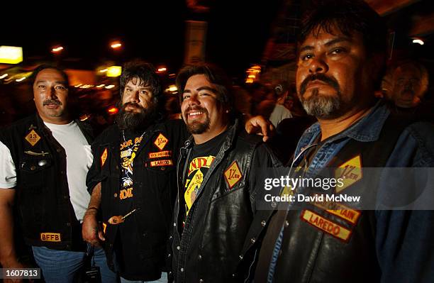 Members of the Loredo, TX chapter of the Bandidos motorcycle club watch the scene on Main Street during the 61st annual Sturgis Motorcycle Rally,...