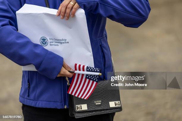 New American citizen hlds an envelope with her U.S. Citizenship certificate following a naturalization ceremony on August 10, 2023 in Utqiagvik,...