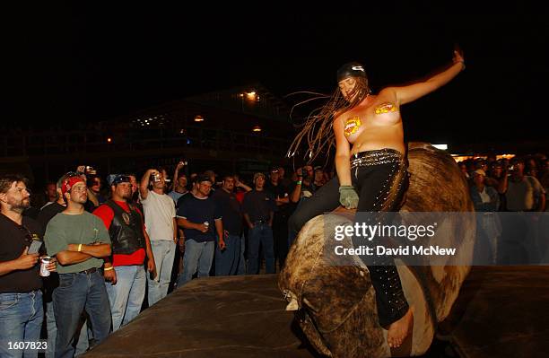 Woman rides the mechanical bull in the Full Throttle Saloon during the 61st annual Sturgis Motorcycle Rally, August 11 in Sturgis, SD. The saloon,...