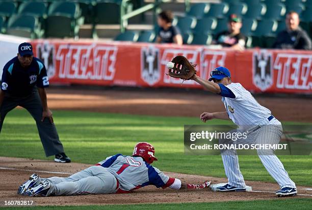 Rey Navarro of Criollos de Caguas of Puerto Rico, slides safe in first base in a match against Magallanes of Venezuela, during the 2013 Caribbean...