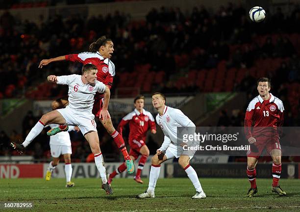 Jack O'Connell of England U19 jumps for a header with Yusuf Yurary of Denmark U19 during the International Match between England U19 and Denmark U19...