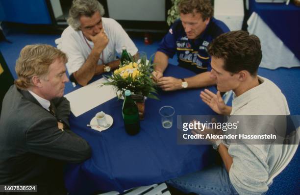 Italian businessman Flavio Briatore , manager of the Benetton Formula One racing team, and German racing driver Michael Schumacher in conversation...