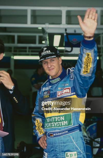 German racing driver Michael Schumacher, wearing a black DEKRA baseball cap and blue coveralls, ahead of the German Grand Prix, held at the...