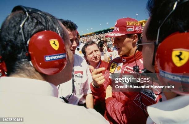 German racing driver Michael Schumacher in conversation with Ferrari team officials ahead of the Australian Grand Prix, held at Melbourne Grand Prix...