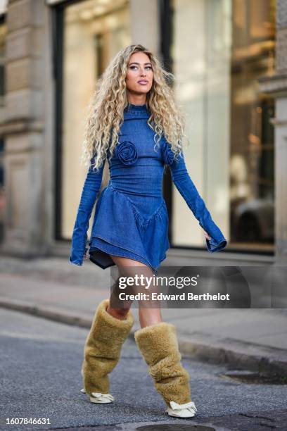 Emili Sindlev wears a blue denim long sleeves / embroidered flower pattern / asymmetric short dress, a brown sheep fur and white latte matte leather...