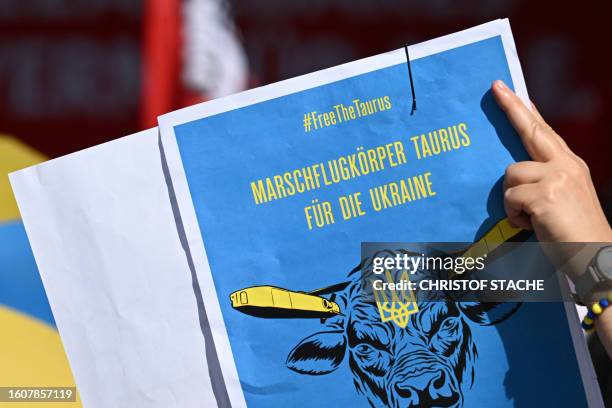 Supporter of Ukraine holds up a placard calling on the German govermnet to supply Ukraine with Taurus air-to-surface cruise missiles at an electoral...