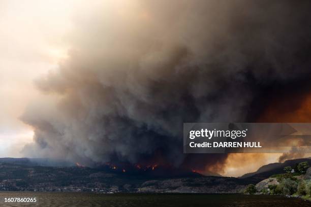 The McDougall Creek wildfire burns in the hills West Kelowna, British Columbia, Canada, on August 17 as seen from Kelowna. Evacuation orders were put...