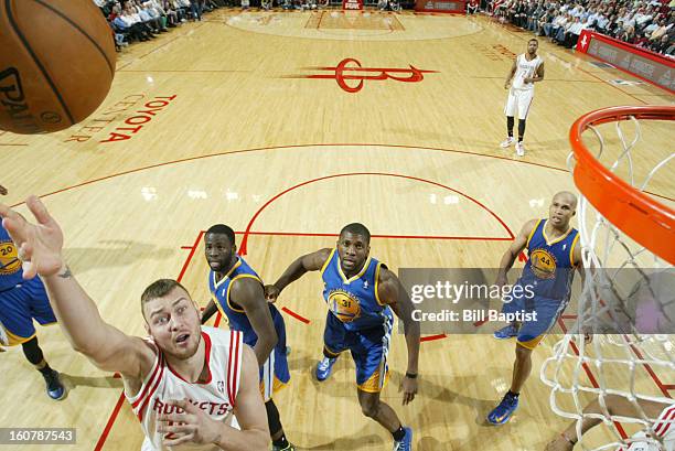 Donatas Motiejunas of the Houston Rockets shoots against the Golden State Warriors on February 5, 2013 at the Toyota Center in Houston, Texas. NOTE...