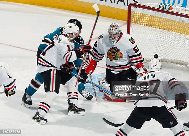 Ryane Clowe of the San Jose Sharks watches as the puck goes in the net against Corey Crawford, Sheldon Brookbank and Johnny Oduya of the Chicago...