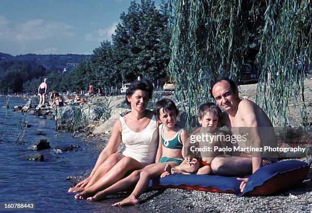 family of four in a bathing suit at the lake - archival family stock pictures, royalty-free photos & images