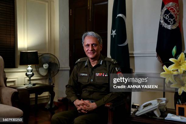 Punjab police chief Usman Anwar poses for a photo during an interview with AFP in Lahore on August 18, 2023. More than 80 Christian homes and 19...