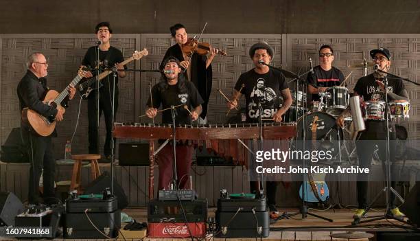 Members of the Mexican cumbia band Son Rompe Pera, with guest musicians Gil Gutierrez, on guitar, and Lyka Kaiumova, on violin, as they perform...
