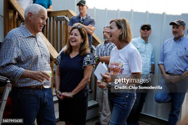 Former U.S. Vice President and current presidential candidate Mike Pence and his wife Karen Pence visit with Iowa Governor Kim Reynolds after...