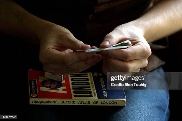 Man rolls a marijuana joint at his home August 8, 2001 in the Dalston section of East London. Cannabis use in the United Kingdom is still illegal,...