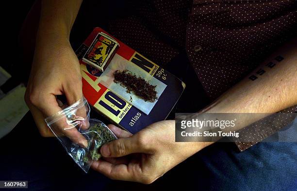 Man rolls a marijuana joint at his home August 8, 2001 in the Dalston section of East London. Cannabis use in the United Kingdom is still illegal,...