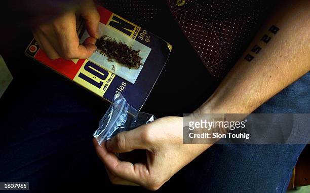 Man rolls a marijuana joint at his home August 8, 2001 in the Dalston section of East London. Cannabis use in the United Kingdom is still illegal,...