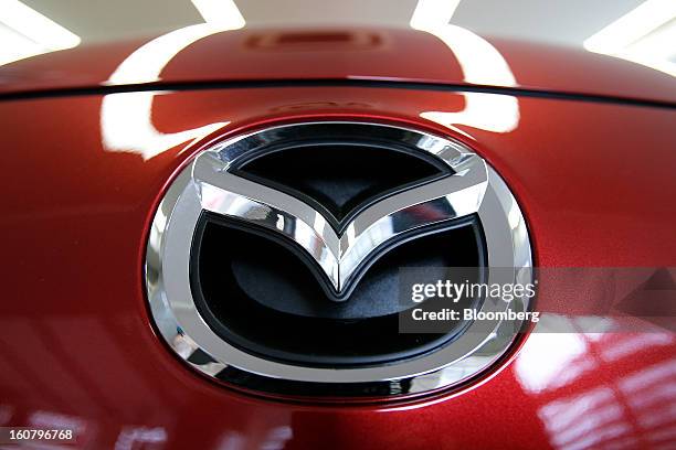 Mazda Motor Corp. Badge is displayed on the front of a Premacy minivan, known as the Mazda 5 outside of Japan, at the company's showroom in Tokyo,...