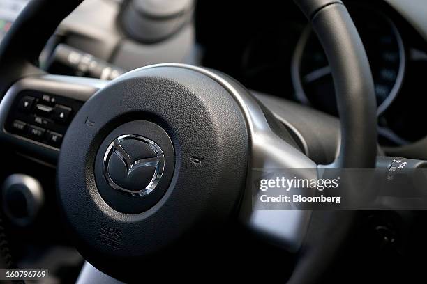 The Mazda Motor Corp. Logo is displayed on the steering wheel of a Demio compact vehicle at the company's showroom in Tokyo, Japan, on Wednesday,...