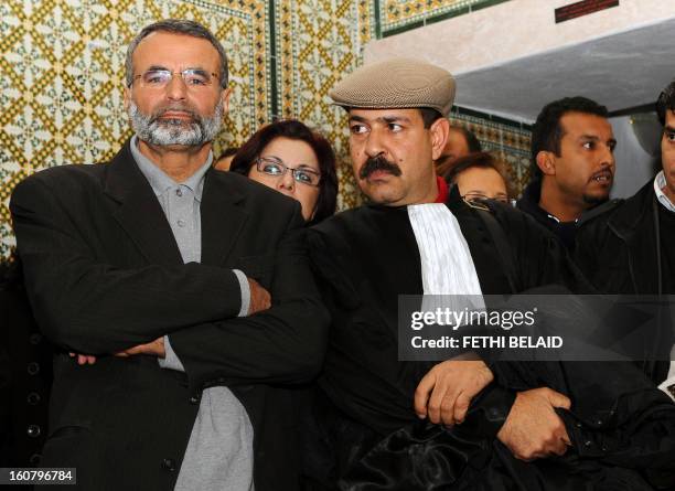 Tunisian lawyers Abderrahman Ayedi and Chokri Belaid look on as they attend a meeting in Tunis on December 29, 2010 to express their solidarity with...