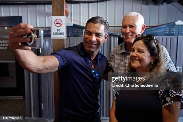 Miami Mayor Francis Suarez poses for a selfie with former U.S. Vice President Mike Pence and his wife Karen Pence in between interviews with Iowa...