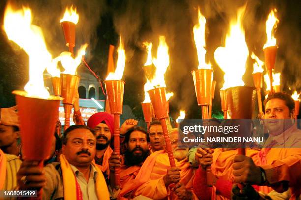 Hindu activists from the Bajrang Dal Party hold torches during a procession in Amritsar on December 6, 2008 as they mark the 16th anniversary of the...