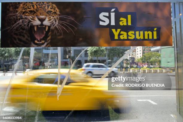 Bus station with an advertisement supporting the halting of the exploitation of crude oil in an important block of the Yasuni National Park in Quito,...