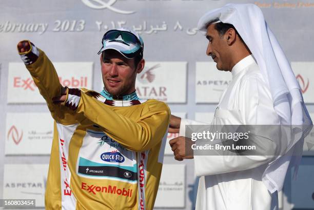 Mark Cavendish of Great Britain and Omega Pharma - Quick Step pulls on the race leaders gold jersey after winning stage four of the Tour of Qatar...