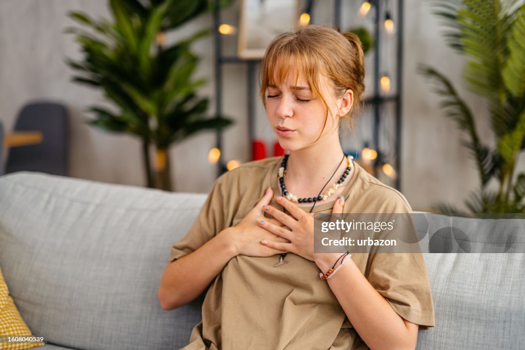 Young Woman Having Chest Pain At Home