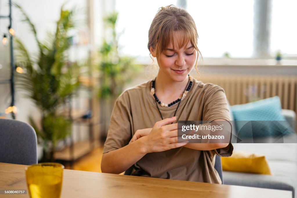 Woman Suffering From Skin Allergy Scratching Her Forearm