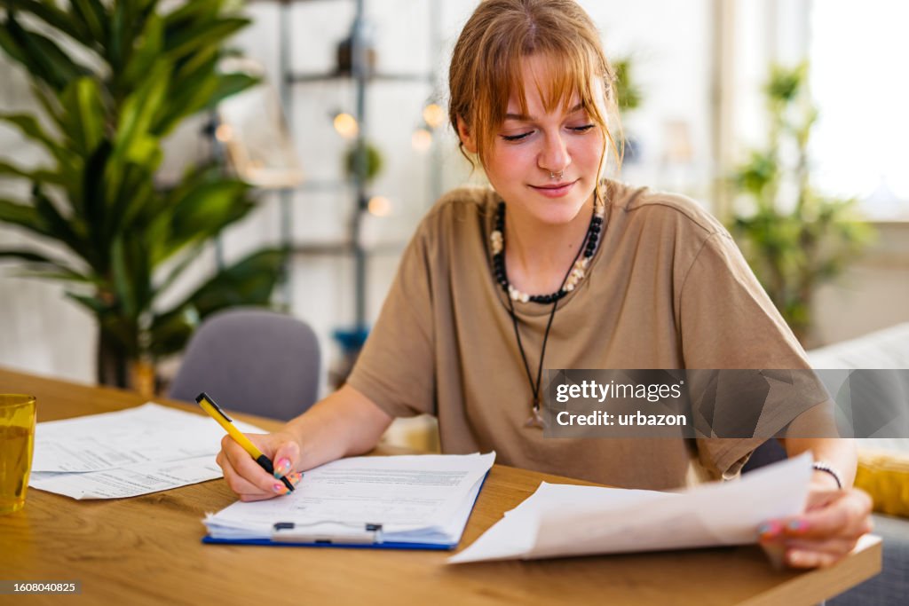 Young Woman Checking Her Finances At Home