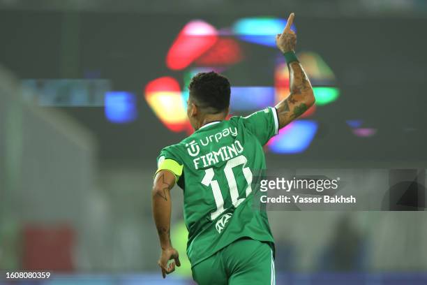 Roberto Firmino of Al-Ahli celebrates after scoring the team's second goal during the Saudi Pro League match between Al-Ahli Saudi and Al-Hazm at the...