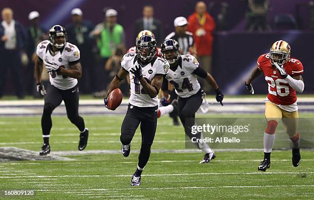 Jacoby Jones of the Baltimore Ravens returns a kick-off 108-yards for a touchdown to open up the second half against Tramaine Brock of the San...