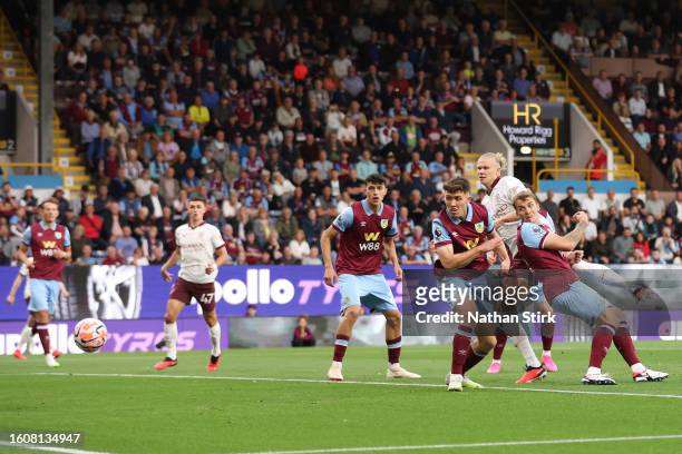 Erling Haaland of Manchester City scores the team's first goal during the Premier League match between Burnley FC and Manchester City at Turf Moor on...
