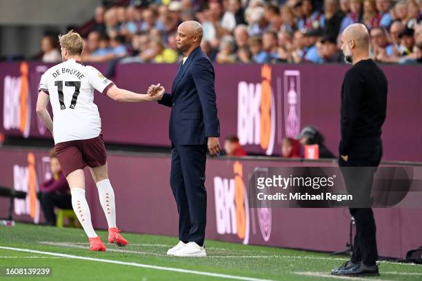 Kevin De Bruyne of Manchester City interacts with Vincent Kompany, Head Coach of Burnley during the Premier League match between Burnley FC and...
