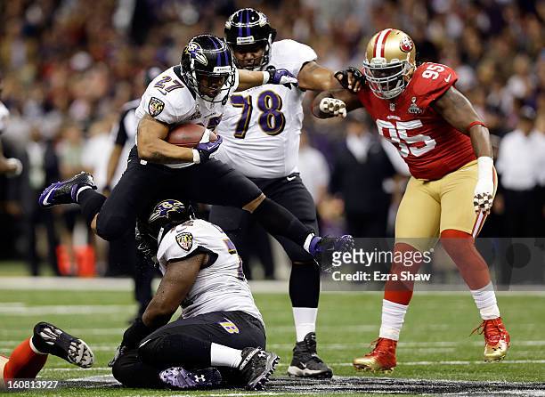 Ray Rice of the Baltimore Ravens leaps over teammate Kelechi Osemele while taking on the San Francisco 49ers during Super Bowl XLVII at the...