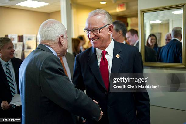 Sen. John McCain, R-Ariz., greets House Armed Services Chairman Buck McKeon, R-Calif., before a press conference to discuss proposals for averting...