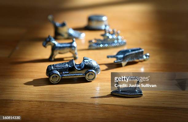In this photo illustration, Monopoly board game pieces are displayed on February 6, 2013 in Fairfax, California. Toy maker Hasbro, Inc. Announced...
