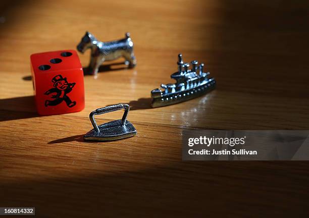 In this photo illustration, Monopoly board game pieces are displayed on February 6, 2013 in Fairfax, California. Toy maker Hasbro, Inc. Announced...