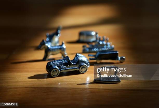 In this photo illustration, Monopoly board game pieces are displayed on February 6, 2013 in Fairfax, California. Toy maker Hasbro, Inc. Announced...