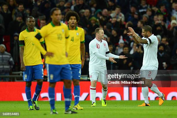 Wayne Rooney of England is congratulated by team-mate Glen Johnson of England after he scored the opening goal during the International friendly...