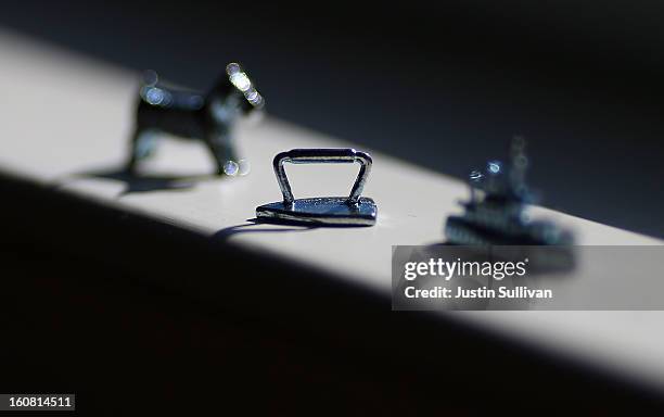 In this photo illustration, Monopoly board game pieces are displayed on February 6, 2013 in Fairfax, California. Toy maker Hasbro, Inc. Announced...