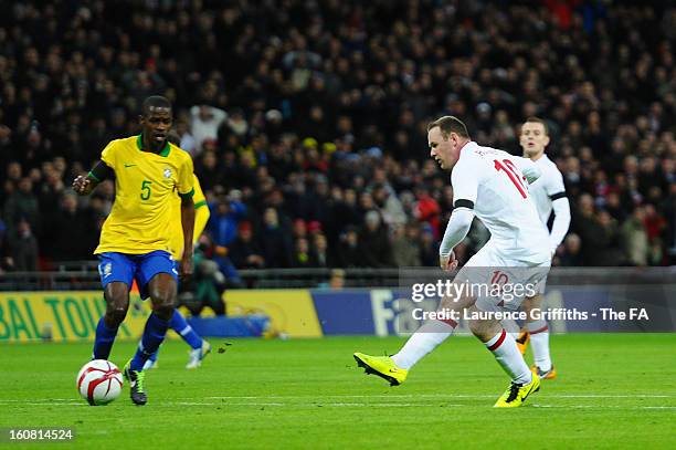 Wayne Rooney of England scores England's first goal past Ramires of Brazil during the International Friendly match between England and Brazil at...