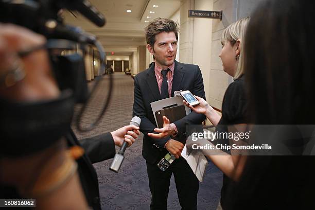 Actor Adam Scott talks with journalists after participating in a news conference hosted by the Mayors Against Illegal Guns and the Law Center to...