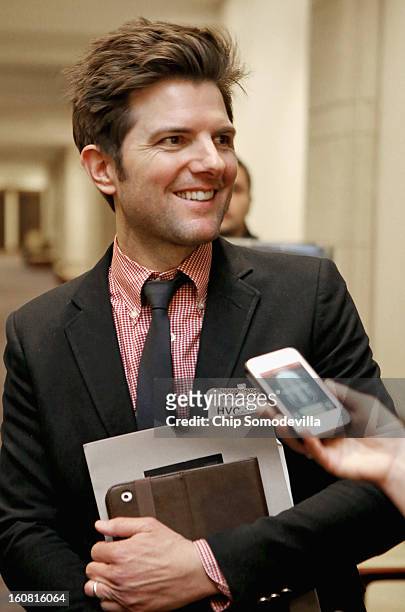 Actor Adam Scott talks with journalists after participating in a news conference hosted by the Mayors Against Illegal Guns and the Law Center to...