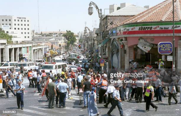 Israeli medics and volunteers treat the injured at the site of a Palestinian suicide bombing August 9, 2001 in Jerusalem, Israel. At least 18 people,...